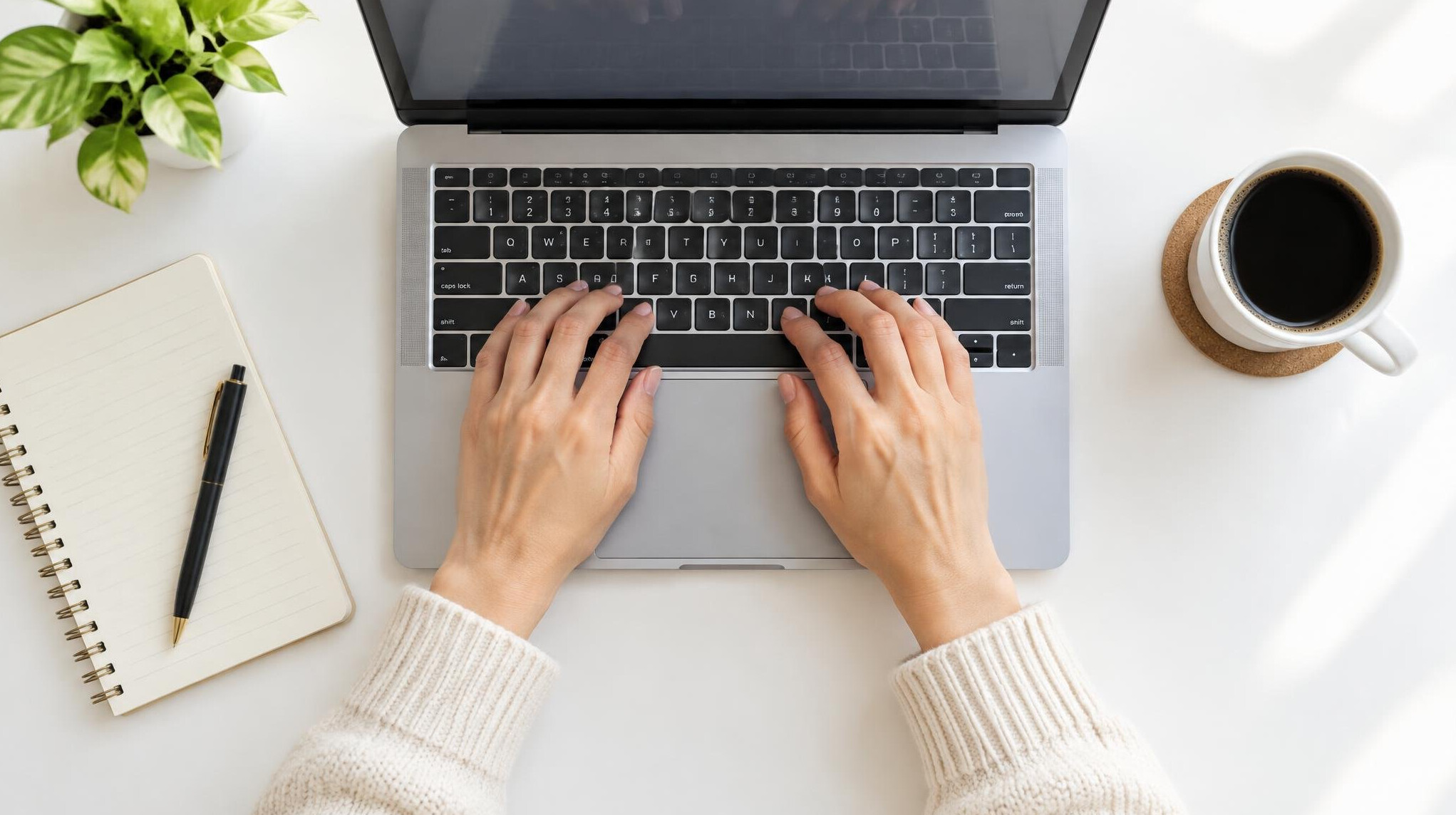 Person typing on a laptop at a desk