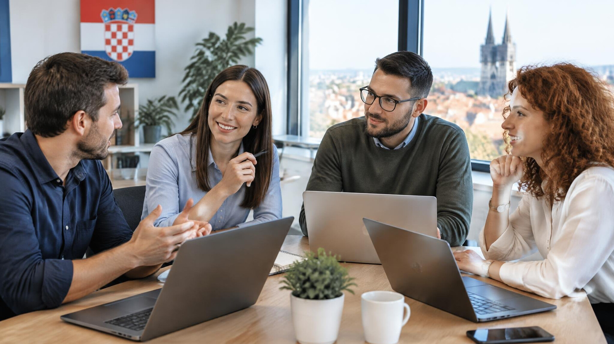 Team of colleagues discussing at a meeting table